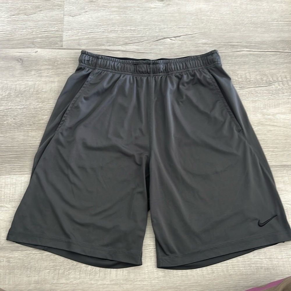 Nike: Dark gray/black drawstring nylon shorts with pockets. Like new.